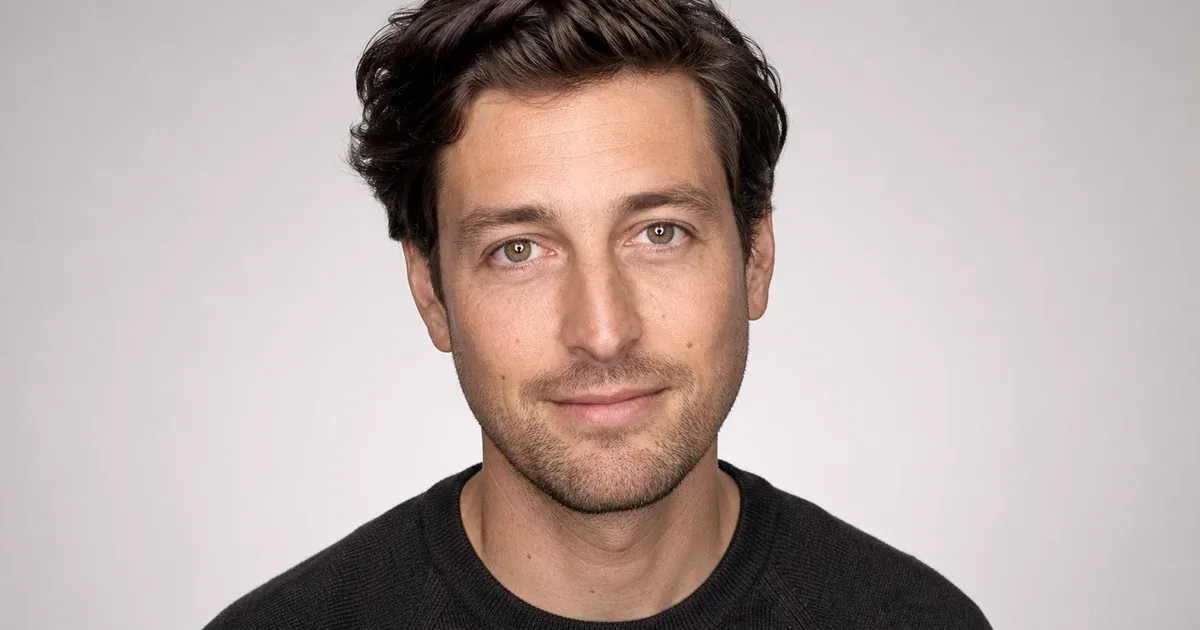 Evenly lit portrait with small circular ring-light catchlights visible in both eyes